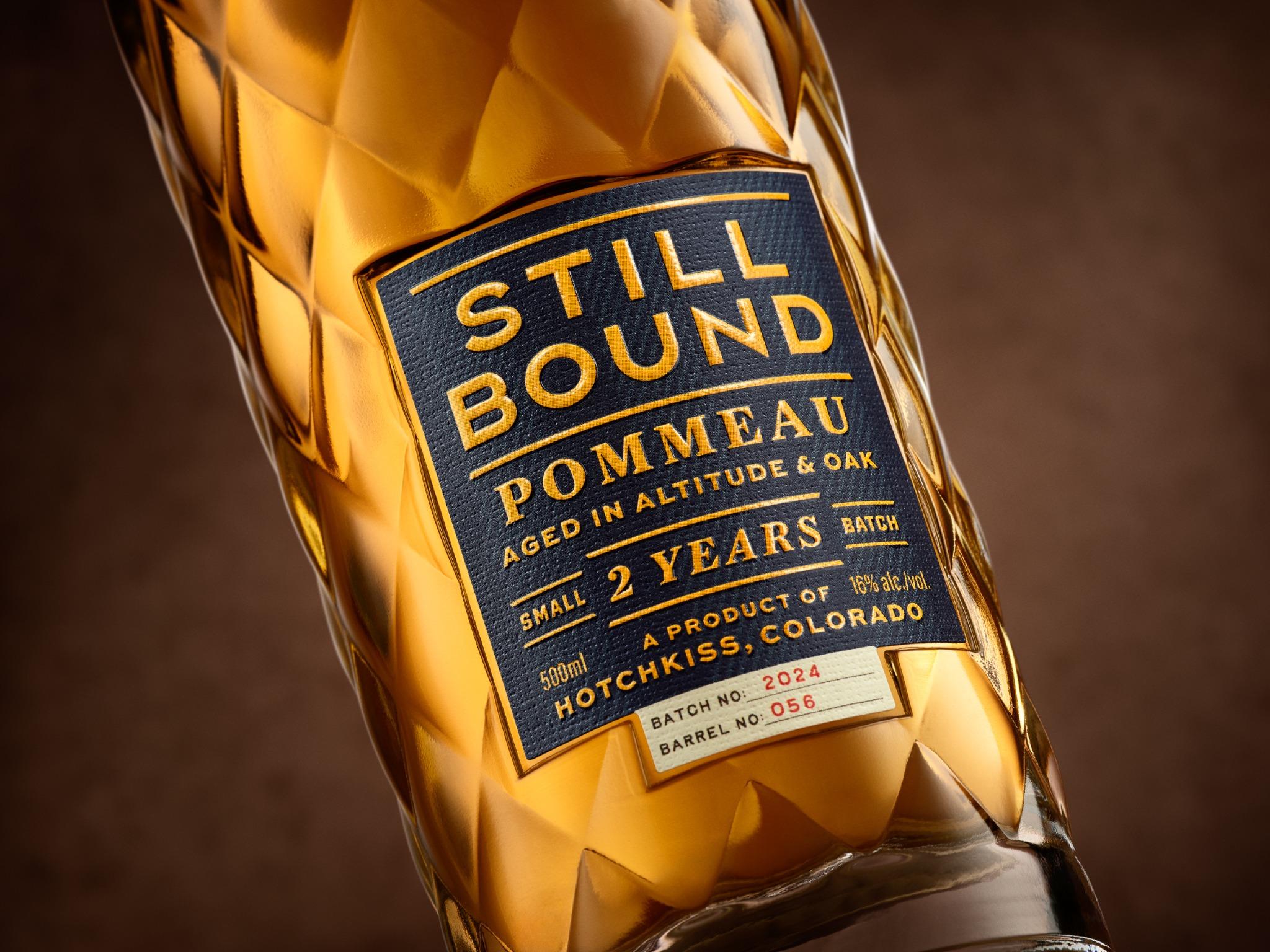 Stillbound Pommeau: amber liquid, diamond glass and navy label